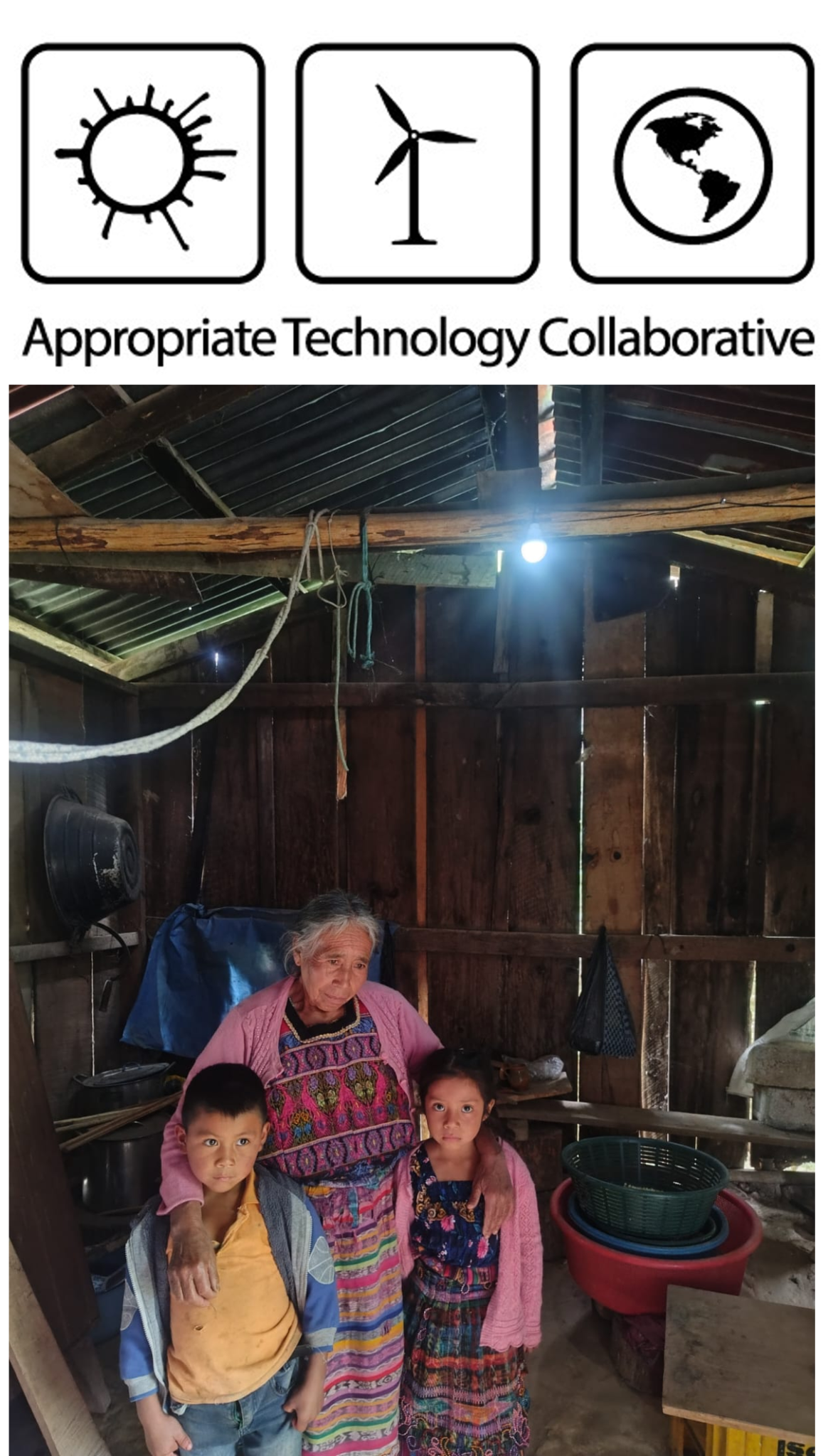A woman and two children beneath a solar-powered light in their home in Guatemala, July 2026.
